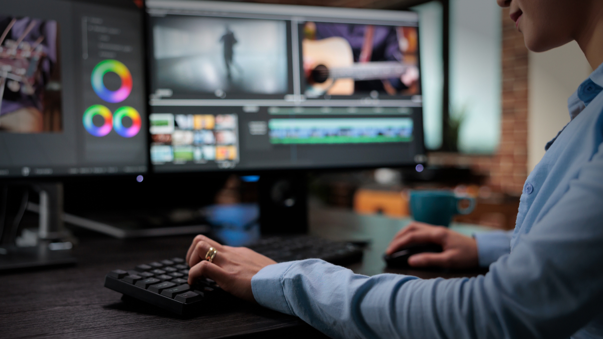 woman editing video on computer monitor